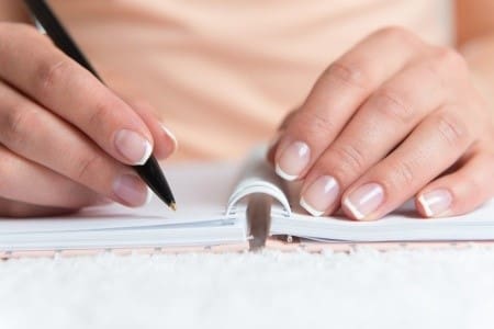 Woman writing in diary